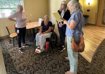 L to R: Angela O’Leary – Work Options Director of Operations - Director of Operations standing, Shantelle Rockman - Access Benefits Coordinator - seated, Julie Stone, Executive Director and Chris Clayton, Impact100 Member - standing